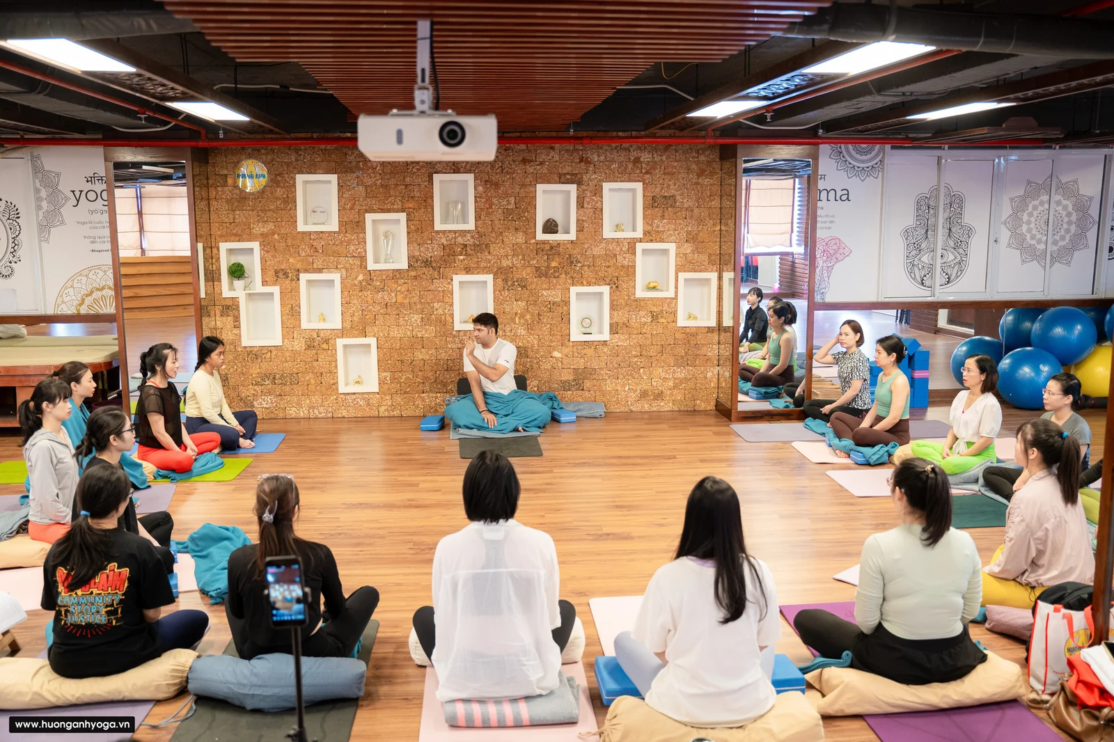 I learned breathing in yoga from Master Raj at his Hanoi studio with students watching.