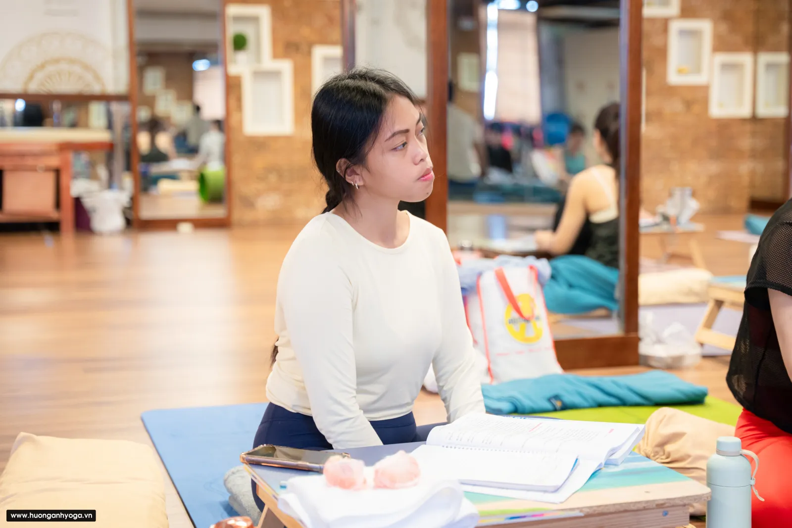 A student sitting quietly before class, the kind of slow breathing in yoga I teach.